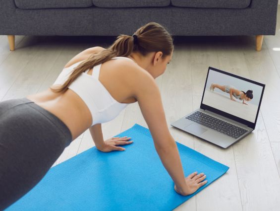 O2 Yogi practicing with an instructor on a computer or tablet